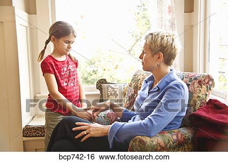 Mother and daughter talking next to window View Large Photo Image Stock Photograph - Mother and daughter talking next to window. Fotosearch