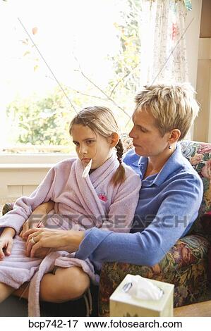 Mother hugging sick daughter View Large Photo Image Stock Photo - Mother hugging sick daughter. Fotosearch
