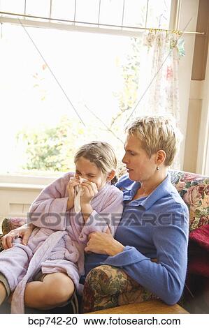 Mother watching sick daughter blow nose View Large Photo Image Stock Image - Mother watching sick daughter blow nose. Fotosearch