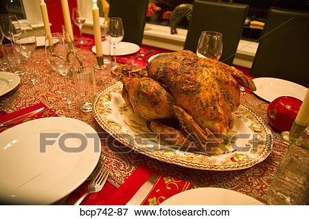 Roasted turkey in center of set table View Large Photo Image Stock Photo - Roasted turkey in center of set table. Fotosearch