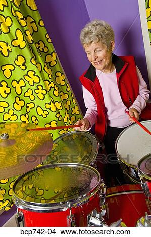 Senior woman playing drums View Large Photo Image Picture - Senior woman playing drums. Fotosearch