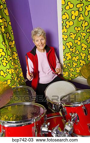 Senior woman playing drums View Large Photo Image Stock Image - Senior woman playing drums. Fotosearch