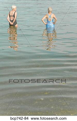 Senior women standing in water View Large Photo Image Picture - Senior women standing in water. Fotosearch