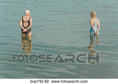 Senior women standing in water View Large Photo Image Stock Image - Senior women standing in water. Fotosearch