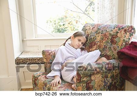 Sick girl sitting in armchair View Large Photo Image Stock Photograph - Sick girl sitting in armchair. Fotosearch