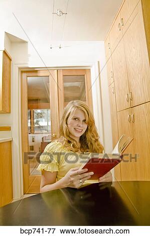 Teenage girl reading at table View Large Photo Image Stock Photo - Teenage girl reading at table. Fotosearch