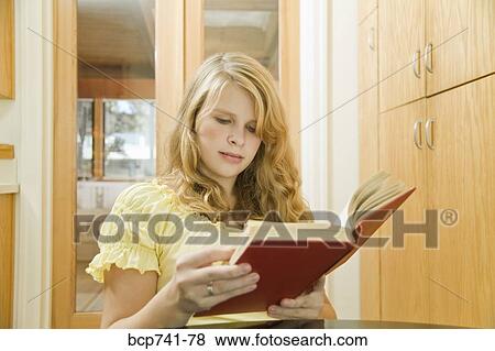 Teenage girl reading at table View Large Photo Image Stock Photo - Teenage girl reading at table. Fotosearch