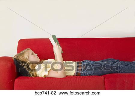 Teenage girl reading on sofa View Large Photo Image Stock Image - Teenage girl reading on sofa. Fotosearch