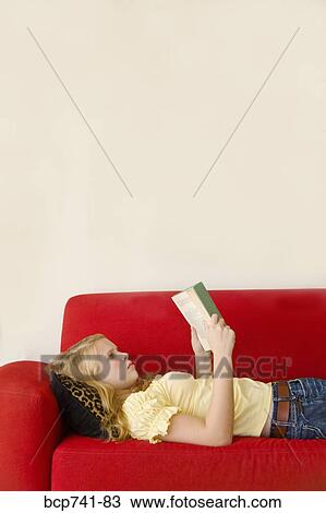 Teenage girl reading on sofa View Large Photo Image Stock Image - Teenage girl reading on sofa. Fotosearch