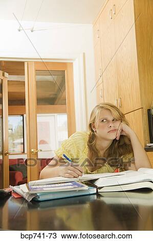Teenage girl studying at table View Large Photo Image Stock Image - Teenage girl studying at table. Fotosearch