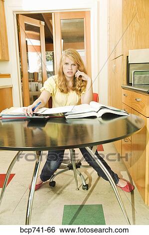 Teenage girl studying at table View Large Photo Image Stock Photograph - Teenage girl studying at table. Fotosearch