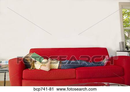 Teenage girl with book over face View Large Photo Image Stock Image - Teenage girl with book over face. Fotosearch