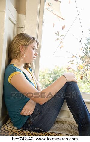 Teenaged girl looking out window View Large Photo Image Stock Image - Teenaged girl looking out window. Fotosearch