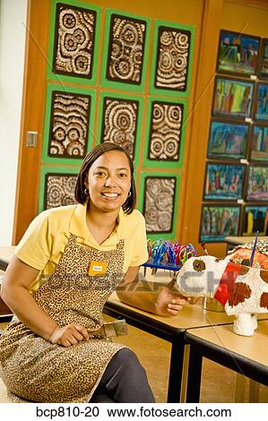 Stock Image - African female art teacher in classroom. Fotosearch