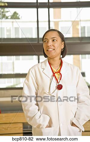 African female doctor with hands in pockets View Large Photo Image Stock Image - African female doctor with hands in pockets. Fotosearch