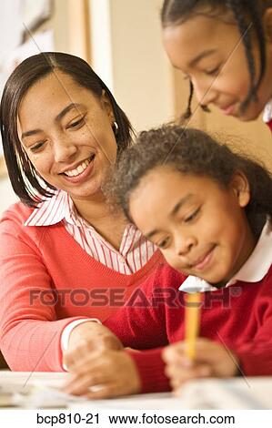 African female teacher helping student View Large Photo Image Stock Image - African female teacher helping student. Fotosearch