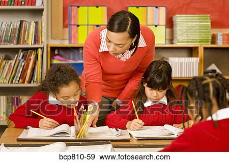 African female teacher helping student View Large Photo Image Stock Photo - African female teacher helping student. Fotosearch