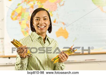 African female teacher holding pencils View Large Photo Image Stock Photo - African female teacher holding pencils. Fotosearch