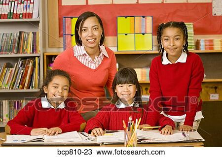 Stock Image - African female teacher with students. Fotosearch