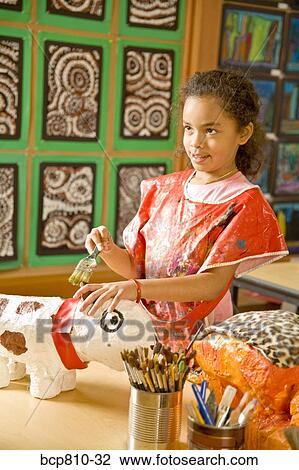 Stock Image - African girl making art project. Fotosearch