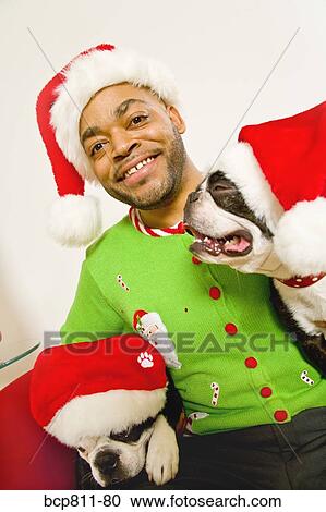 African man and dogs wearing Santa Claus hats View Large Photo Image Stock Image - African man and dogs wearing Santa Claus hats. Fotosearch
