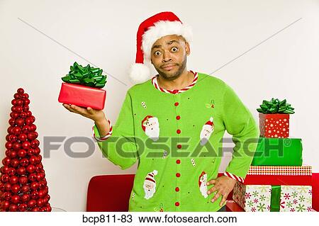 African man holding Christmas gift View Large Photo Image Stock Image - African man holding Christmas gift. Fotosearch