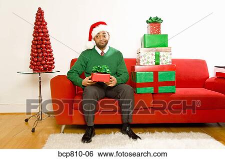 African man holding Christmas gift View Large Photo Image Stock Photograph - African man holding Christmas gift. Fotosearch