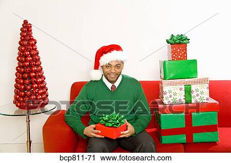 African man next to stack of Christmas gifts View Large Photo Image Stock Image - African man next to stack of Christmas gifts. Fotosearch