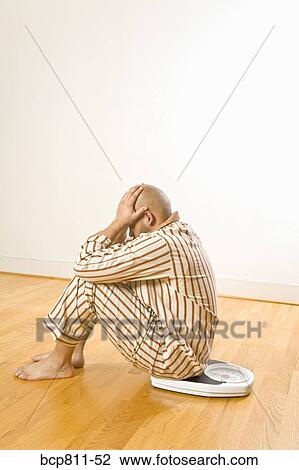 African man sitting on scale View Large Photo Image Stock Image - African man sitting on scale. Fotosearch