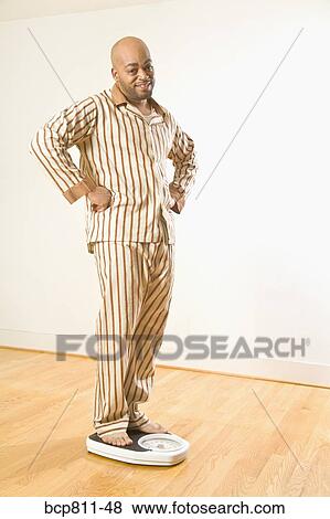African man standing on scale View Large Photo Image Stock Photo - African man standing on scale. Fotosearch
