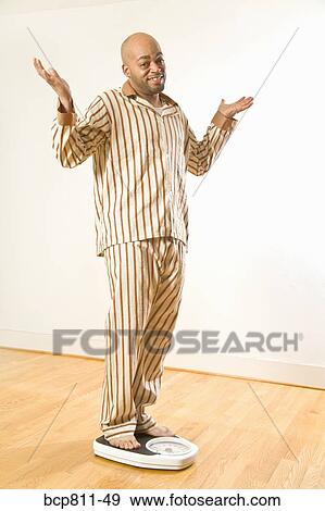 African man standing on scale View Large Photo Image Stock Photo - African man standing on scale. Fotosearch