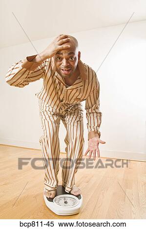 African man standing on scale View Large Photo Image Stock Photography - African man standing on scale. Fotosearch