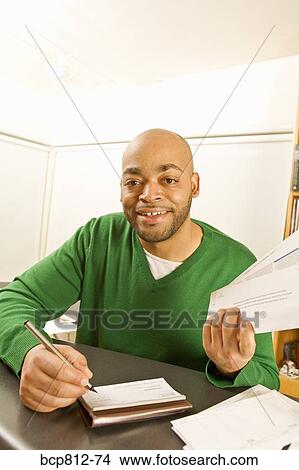 African man writing check View Large Photo Image Picture - African man writing check. Fotosearch