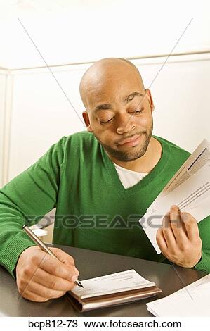 African man writing check View Large Photo Image Stock Image - African man writing check. Fotosearch