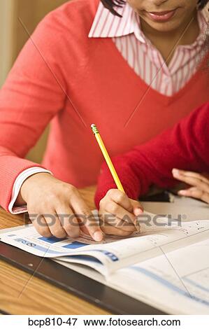 African mother helping daughter with homework View Large Photo Image Stock Photo - African mother helping daughter with homework. Fotosearch