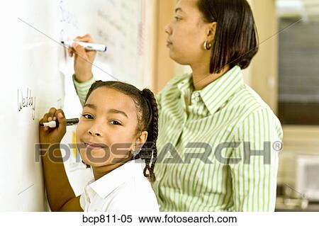 African teacher and student writing on whiteboard View Large Photo Image Stock Photography - African teacher and student writing on whiteboard. Fotosearch
