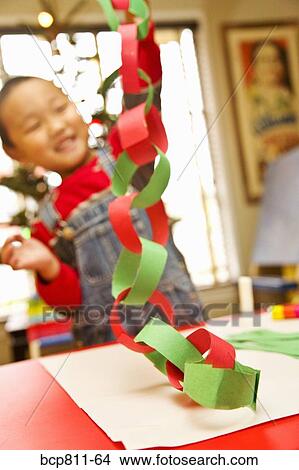 Asian boy making paper chain View Large Photo Image Picture - Asian boy making paper chain. Fotosearch