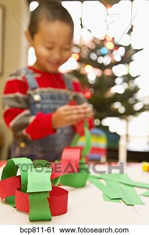 Asian boy making paper chain View Large Photo Image Stock Image - Asian boy making paper chain. Fotosearch