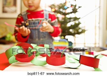 Asian boy making paper chain View Large Photo Image Stock Photo - Asian boy making paper chain. Fotosearch