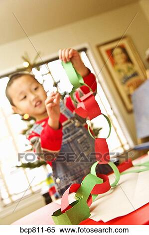Stock Photography - Asian boy making paper chain. Fotosearch