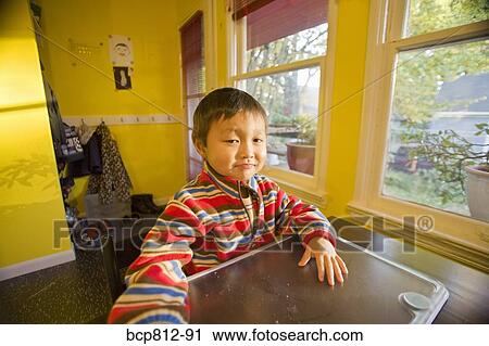 Asian boy sitting at table View Large Photo Image Stock Image - Asian boy sitting at table. Fotosearch