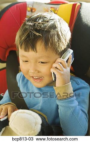 Asian boy talking on cell phone View Large Photo Image Stock Image - Asian boy talking on cell phone. Fotosearch