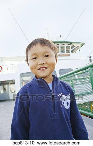 Asian boy wearing sweatshirt on ferry View Large Photo Image Stock Image - Asian boy wearing sweatshirt on ferry. Fotosearch