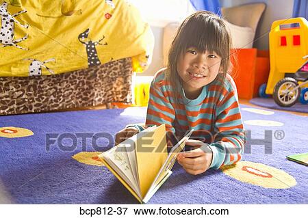 Asian girl reading book View Large Photo Image Stock Photo - Asian girl reading book. Fotosearch