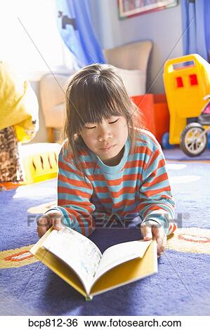 Asian girl reading book View Large Photo Image Stock Photograph - Asian girl reading book. Fotosearch