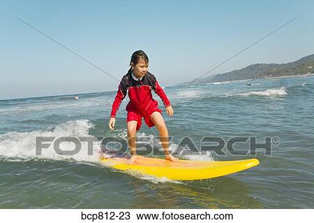 Asian girl surfing View Large Photo Image Stock Image - Asian girl surfing. Fotosearch