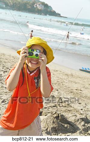 Asian girl taking photograph at beach View Large Photo Image Stock Image - Asian girl taking photograph at beach. Fotosearch