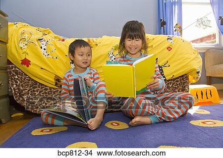 Asian siblings reading books View Large Photo Image Picture - Asian siblings reading books. Fotosearch