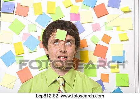 Businessman with adhesive note on forehead View Large Photo Image Stock Image - Businessman with adhesive note on forehead. Fotosearch