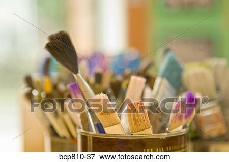 Stock Photo - Close up of paintbrushes in cans. Fotosearch